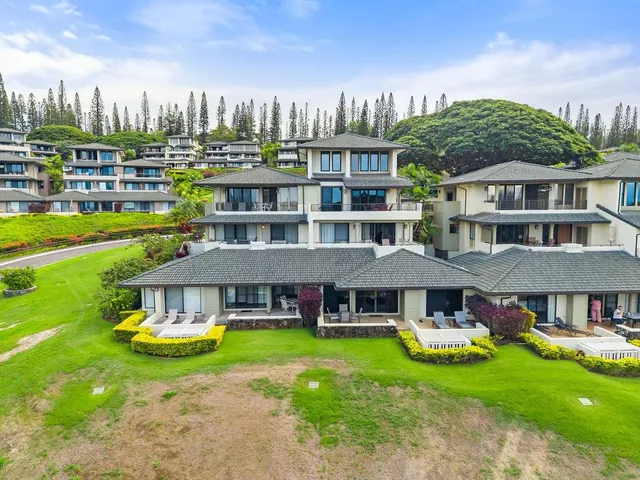 a front view of a residential apartment building with a yard table and chairs