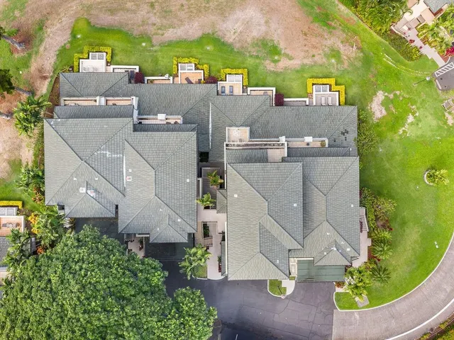 an aerial view of residential houses with outdoor space and street view