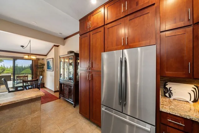 a kitchen with stainless steel appliances granite countertop a refrigerator and a stove
