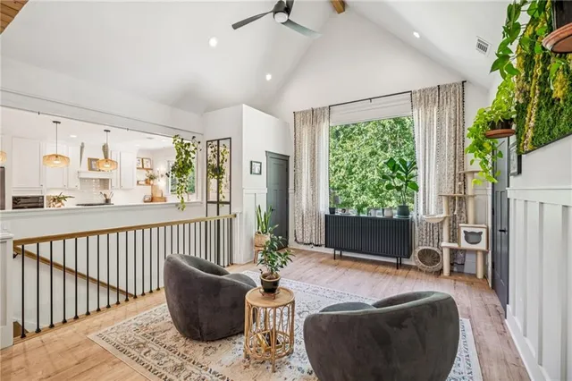 a living room with furniture and a potted plant