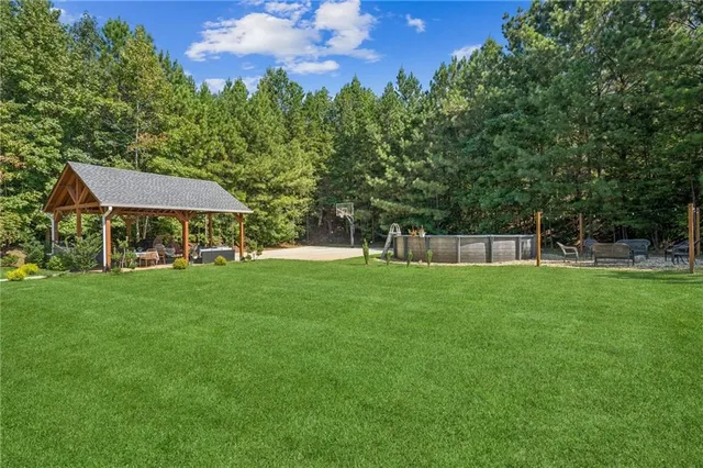 an aerial view of a house with a yard and outdoor seating