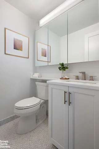 a bathroom with a sink toilet and mirror