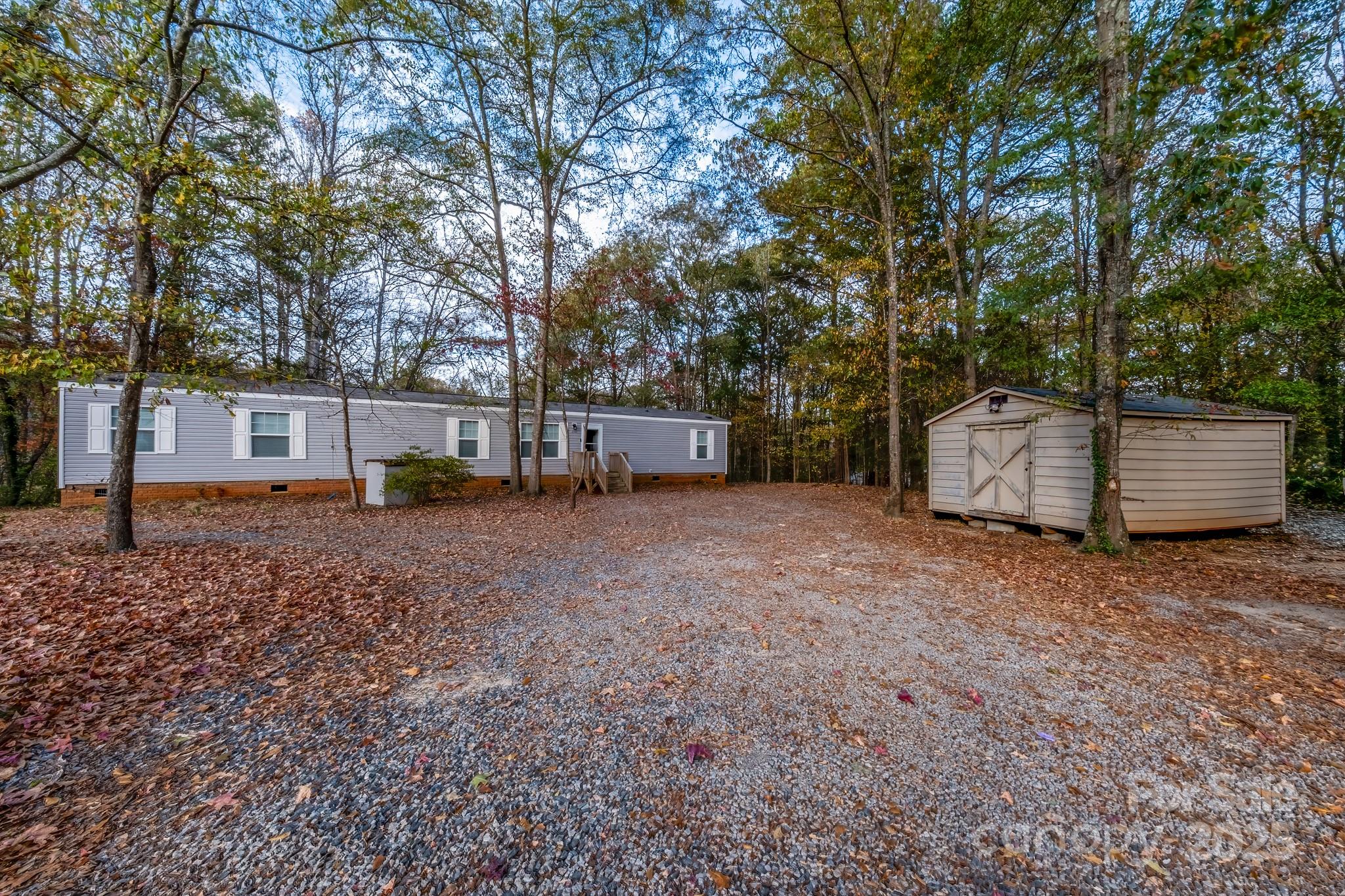 a view of a backyard with large trees