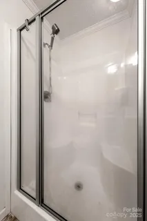 a bathroom with a granite countertop sink a large mirror a vanity and window