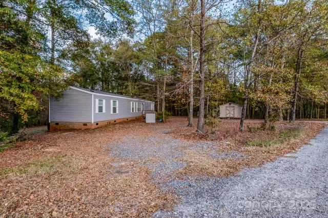 a view of a house with a yard and tree s
