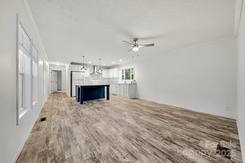 a view of kitchen and hall with wooden floor