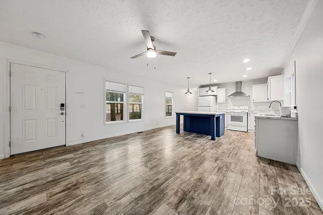 a kitchen with kitchen island a sink stainless steel appliances and cabinets
