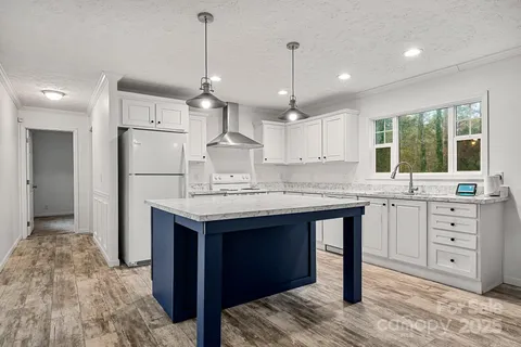 an empty room with chandelier fan