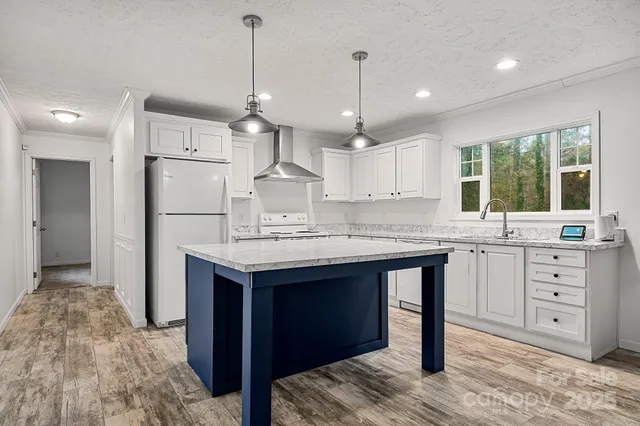 an empty room with chandelier fan