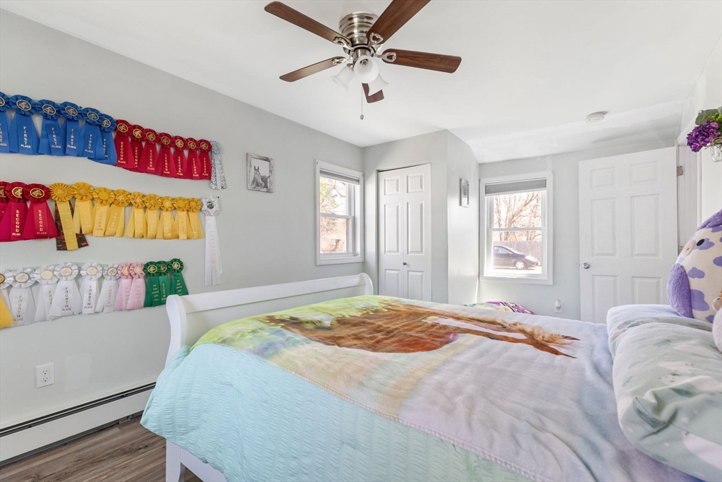 11 Mayflower Road Norton, MA 02766 - Photo 13 of 22 a bedroom with a bed and a chandelier