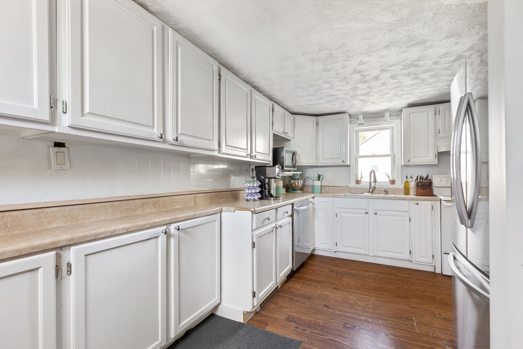 11 Mayflower Road Norton, MA 02766 - Photo 15 of 22 a kitchen with granite countertop white cabinets and white appliances