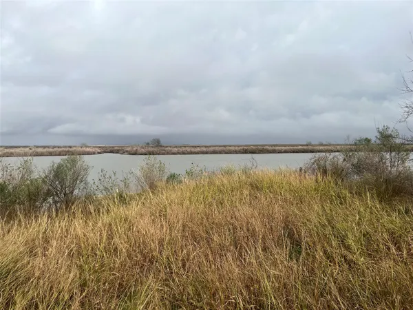a view of a lake with houses in the back