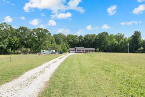 a view of a swimming pool with an outdoor seating and a yard