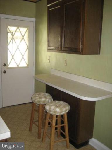 207 Riverthorn Road Middle River, MD 21220 - Photo 5 of 8 a view of a room that has a table and chair in it