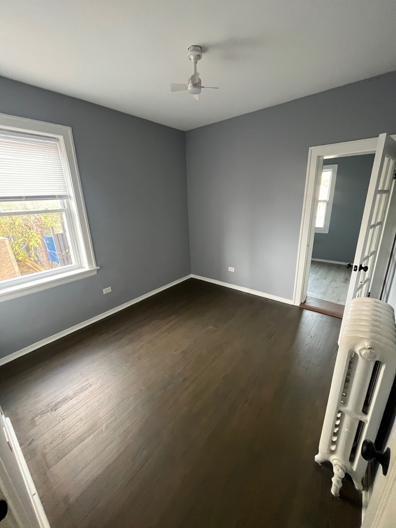 5115 South California Avenue, Unit 1 Chicago, IL 60632 - Photo 11 of 13 an empty room with windows