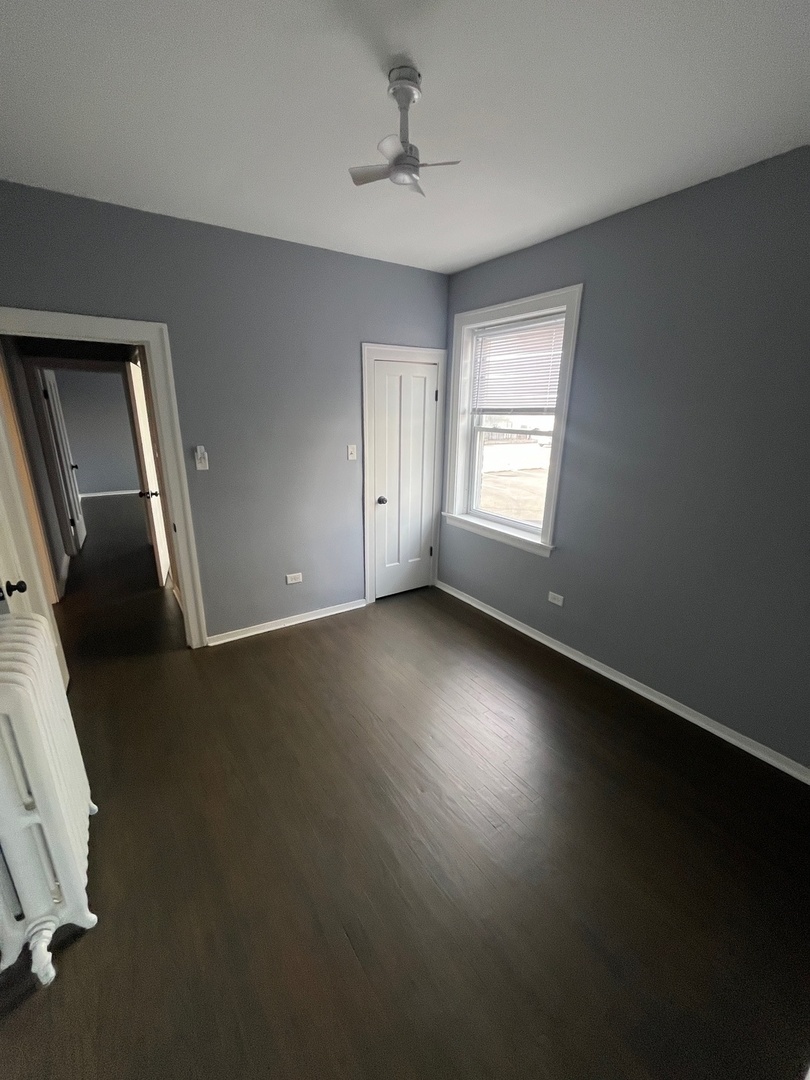 5115 South California Avenue, Unit 1 Chicago, IL 60632 - Photo 12 of 13 wooden floor in an empty room with a window