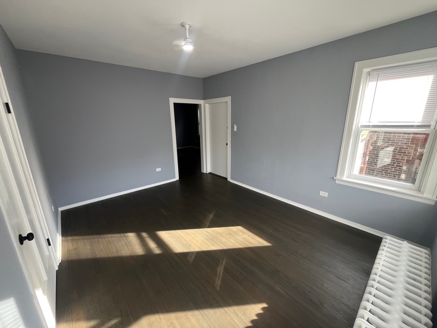 5115 South California Avenue, Unit 1 Chicago, IL 60632 - Photo 3 of 13 wooden floor in an empty room with a window