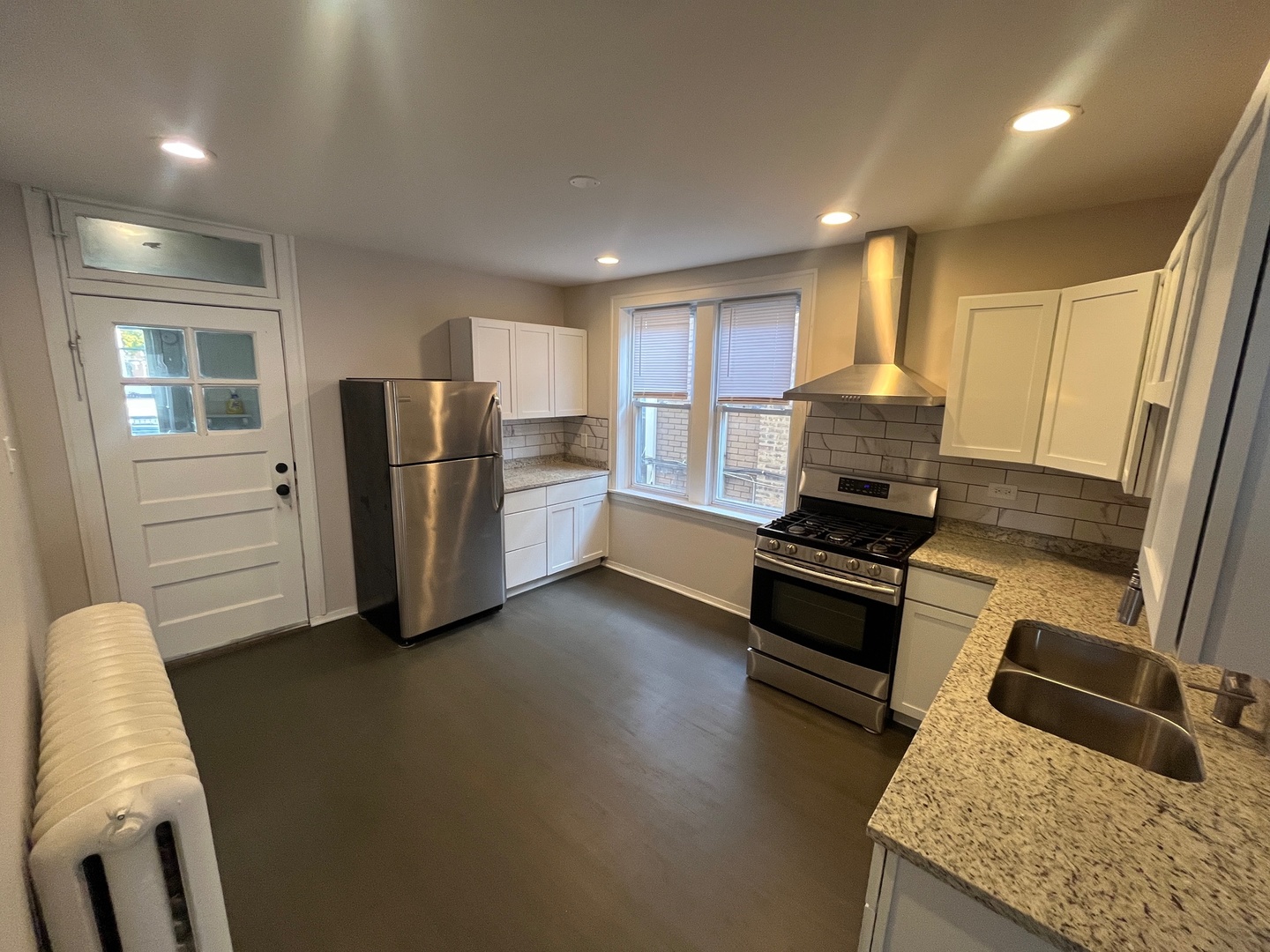 5115 South California Avenue, Unit 1 Chicago, IL 60632 - Photo 6 of 13 a kitchen with stainless steel appliances granite countertop a refrigerator stove microwave and sink