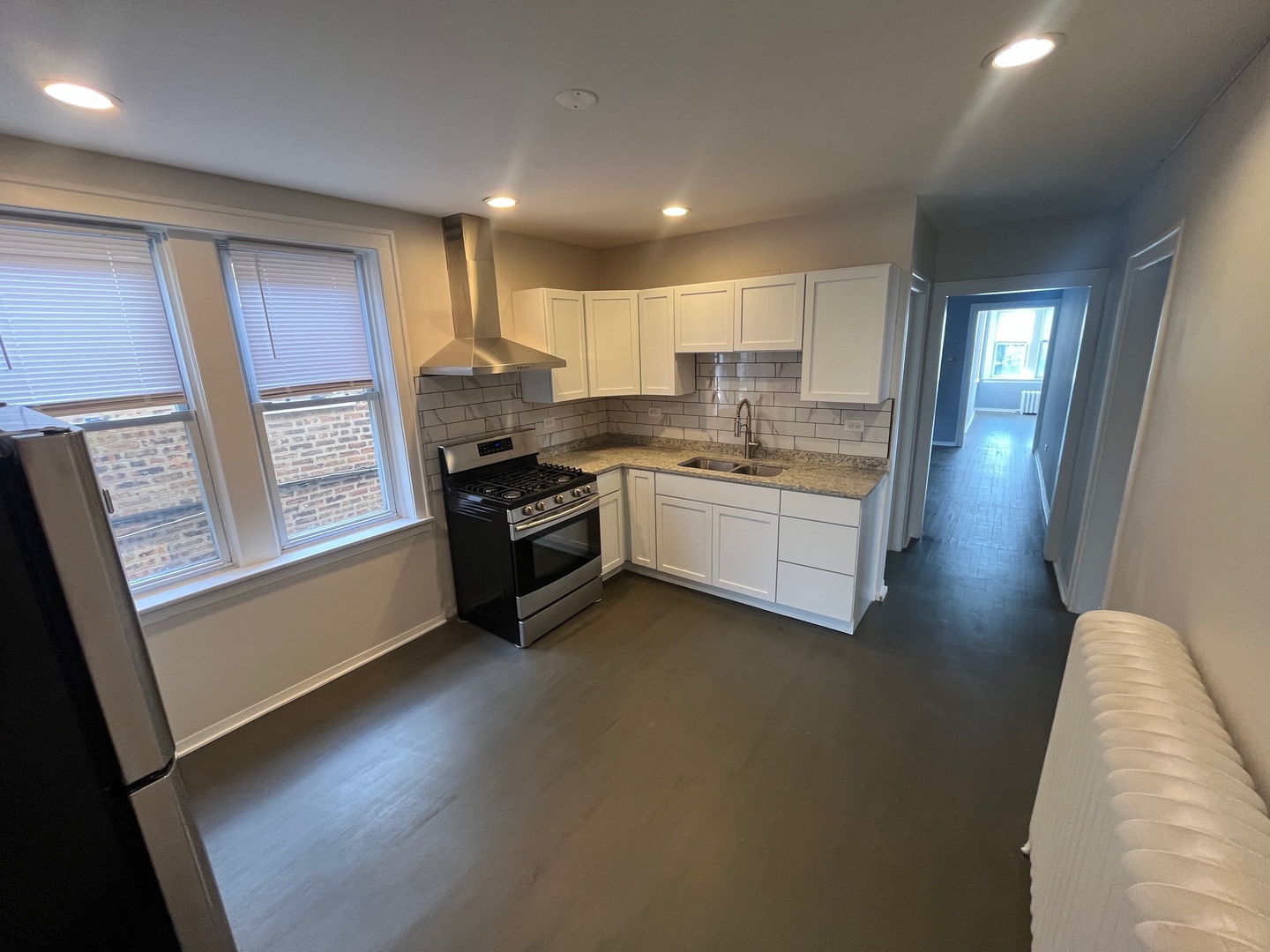 5115 South California Avenue, Unit 1 Chicago, IL 60632 - Photo 7 of 13 a kitchen with stainless steel appliances granite countertop a stove a sink and a refrigerator