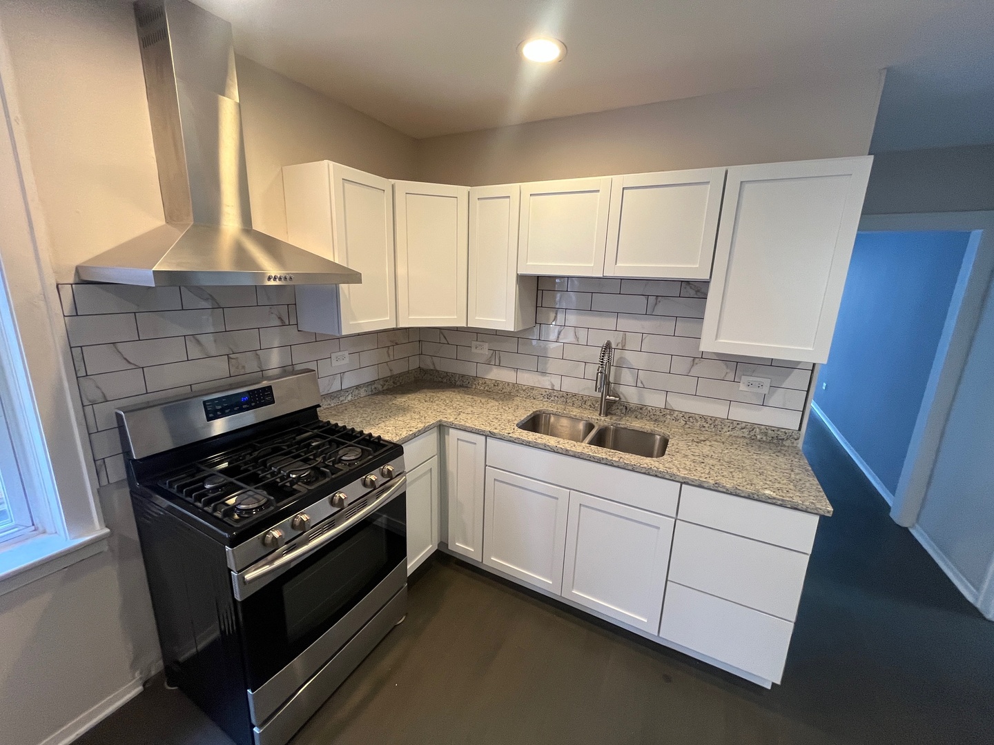 5115 South California Avenue, Unit 1 Chicago, IL 60632 - Photo 8 of 13 a kitchen with sink a stove and cabinets
