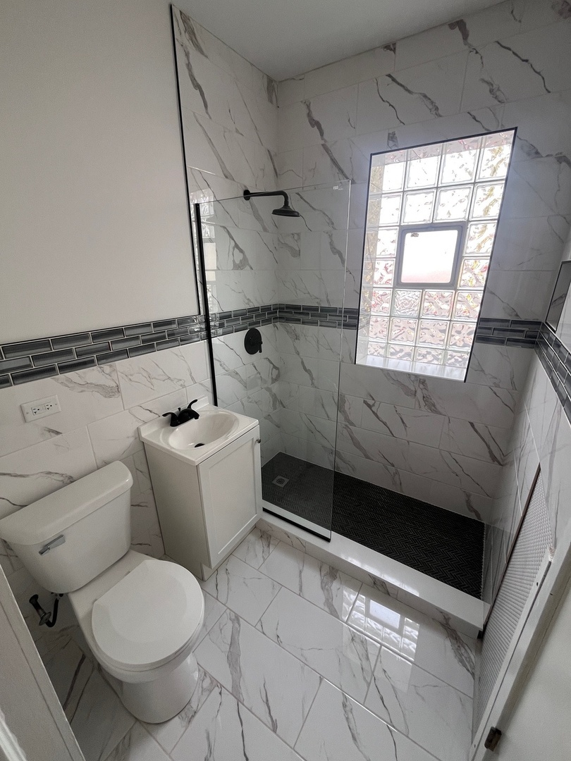 5115 South California Avenue, Unit 1 Chicago, IL 60632 - Photo 9 of 13 a bathroom with a toilet and a shower
