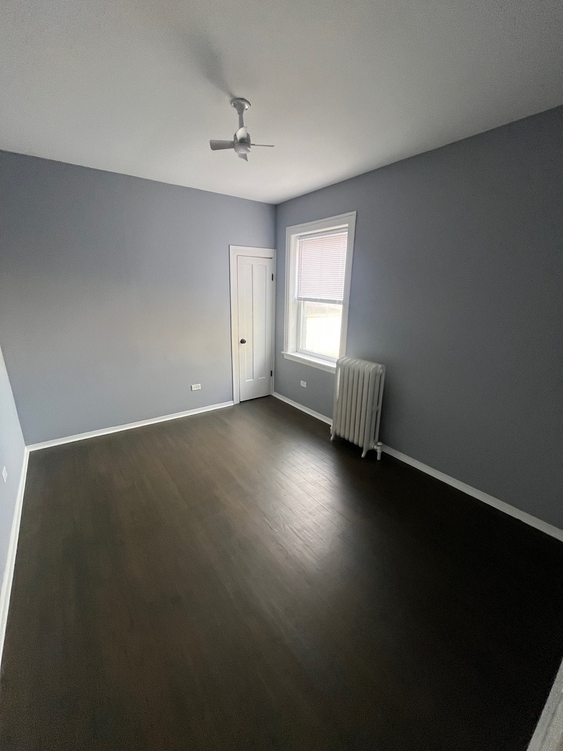 5115 South California Avenue, Unit 1 Chicago, IL 60632 - Photo 10 of 13 a view of room window and wooden floor