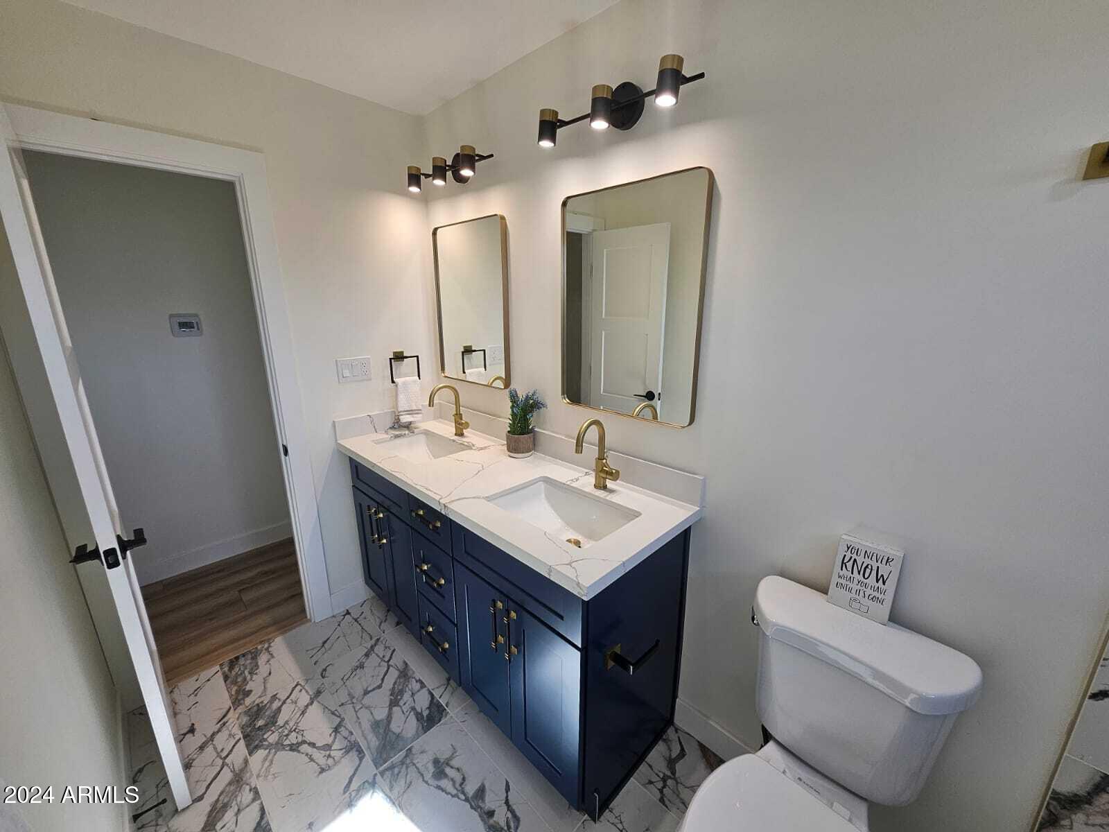 1553 West 5th Place Tempe, AZ 85281 - Photo 18 of 30 a bathroom with a toilet sink and mirror