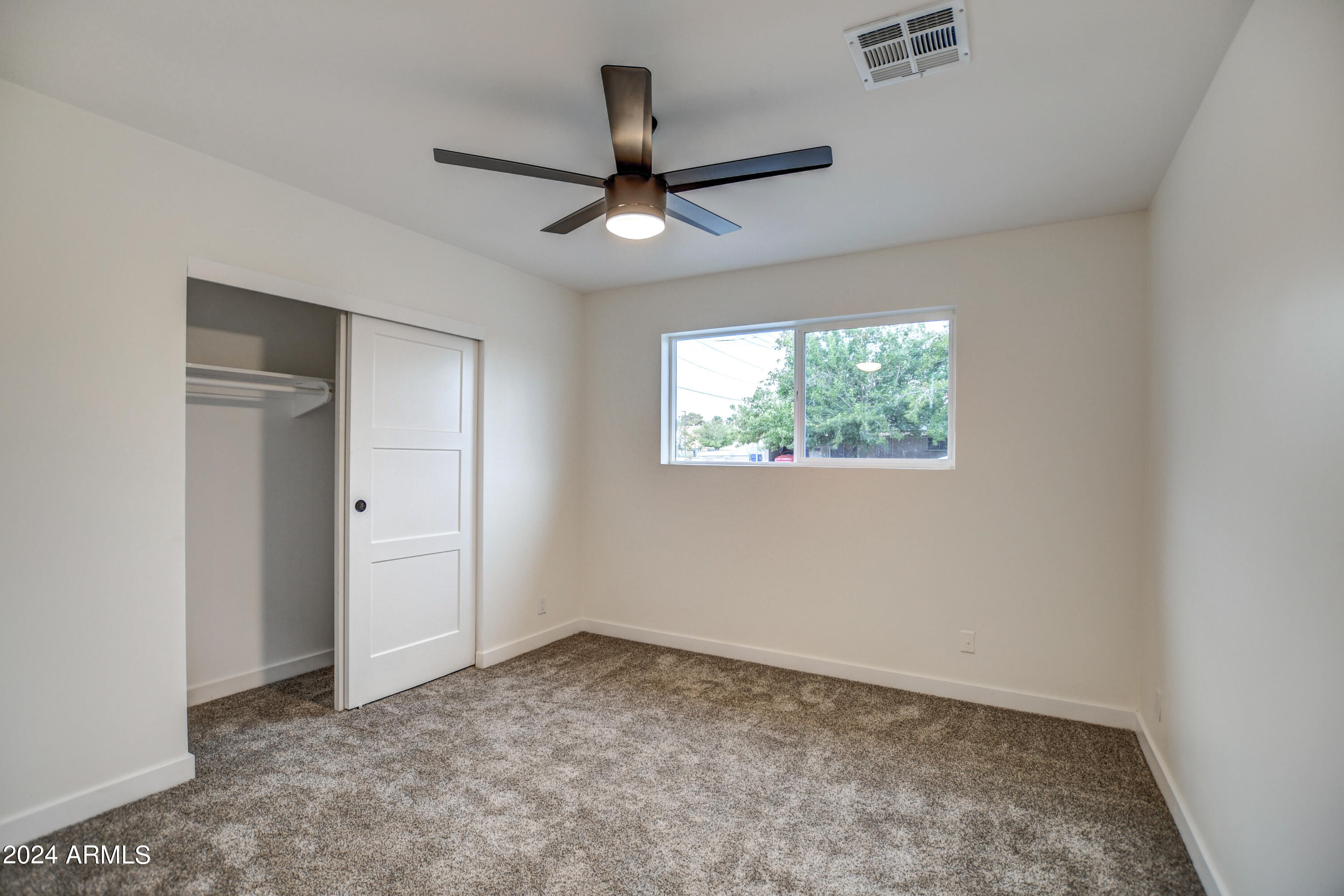 1553 West 5th Place Tempe, AZ 85281 - Photo 23 of 30 an empty room with windows and fan