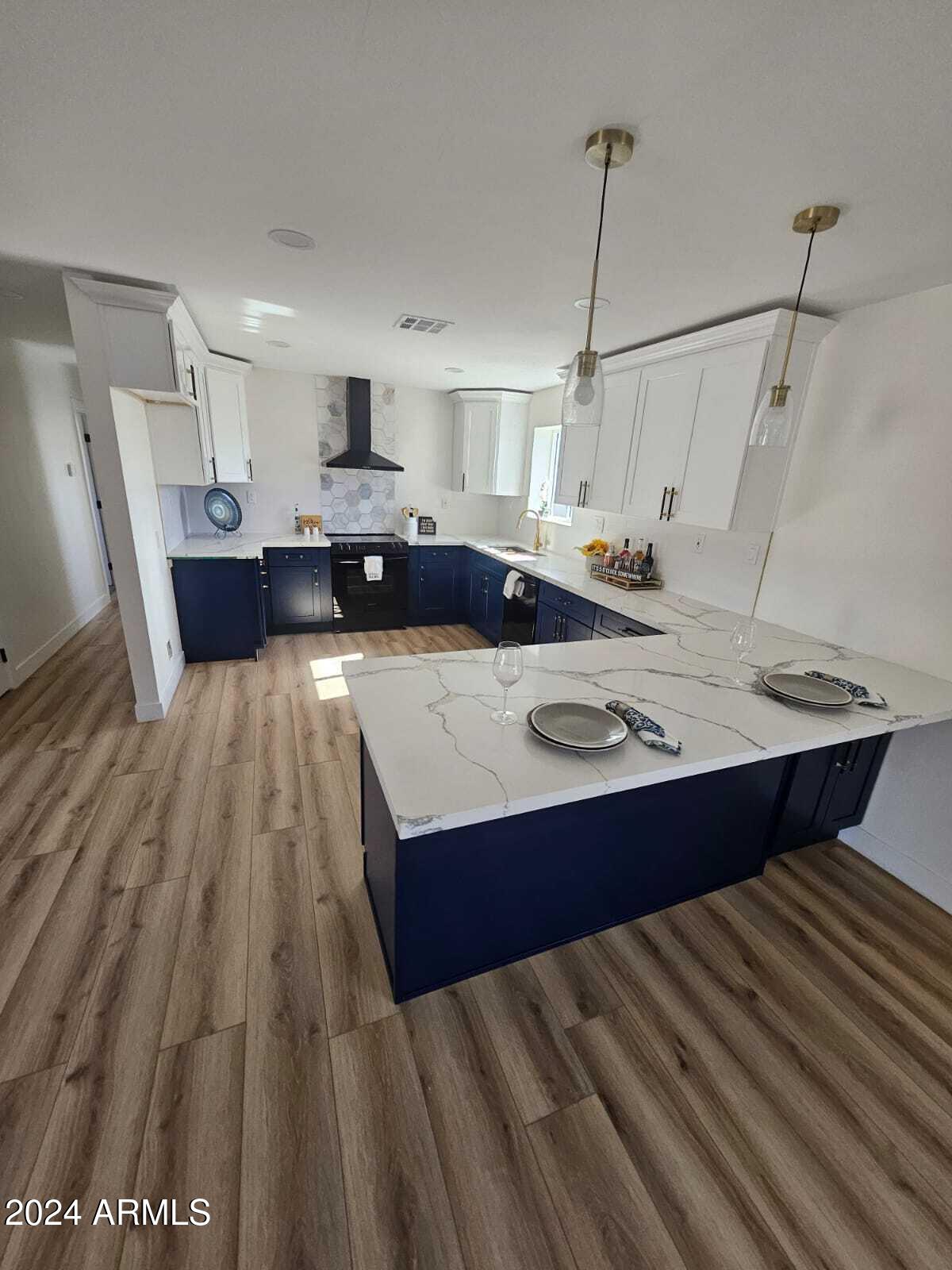 1553 West 5th Place Tempe, AZ 85281 - Photo 6 of 30 a living room with a bed furniture and a wooden floor