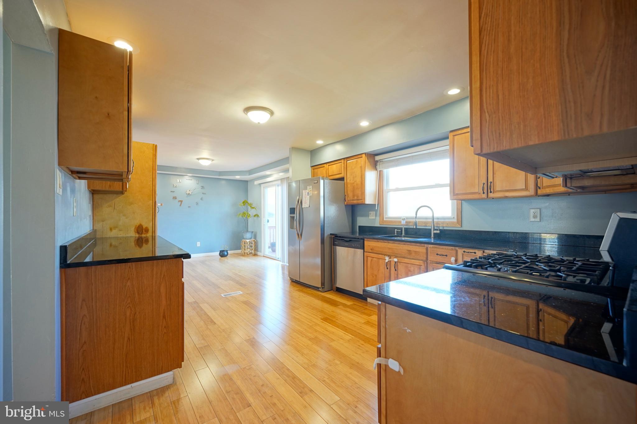 523 Carver Court Lawnside, NJ 08045 - Photo 17 of 39 a kitchen with stainless steel appliances granite countertop a stove a sink and a refrigerator