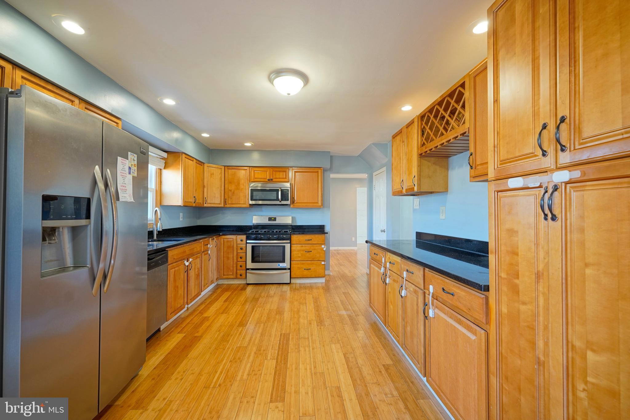 523 Carver Court Lawnside, NJ 08045 - Photo 19 of 39 a large kitchen with stainless steel appliances a large counter top a stove and a refrigerator