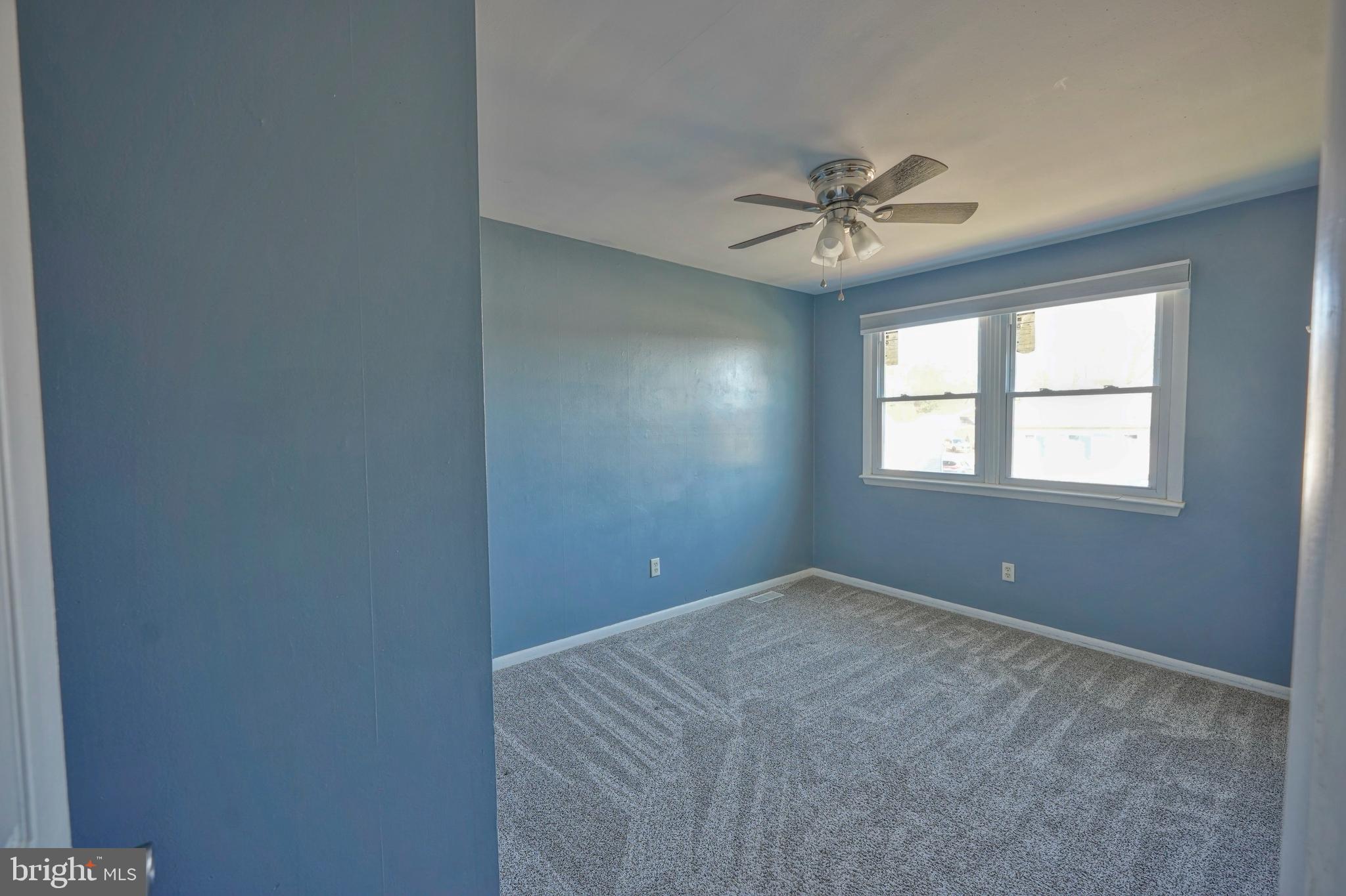 523 Carver Court Lawnside, NJ 08045 - Photo 33 of 39 an empty room with windows and ceiling fan