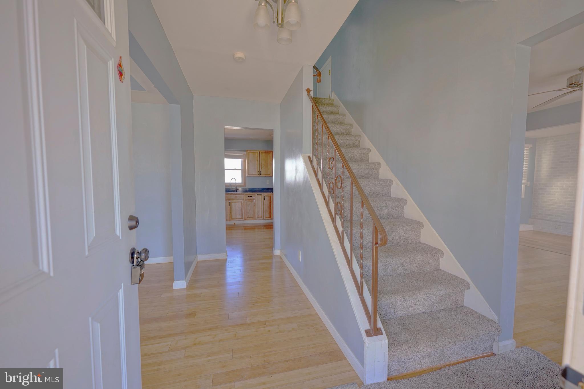 523 Carver Court Lawnside, NJ 08045 - Photo 10 of 39 a view of a hallway with wooden floor and staircase