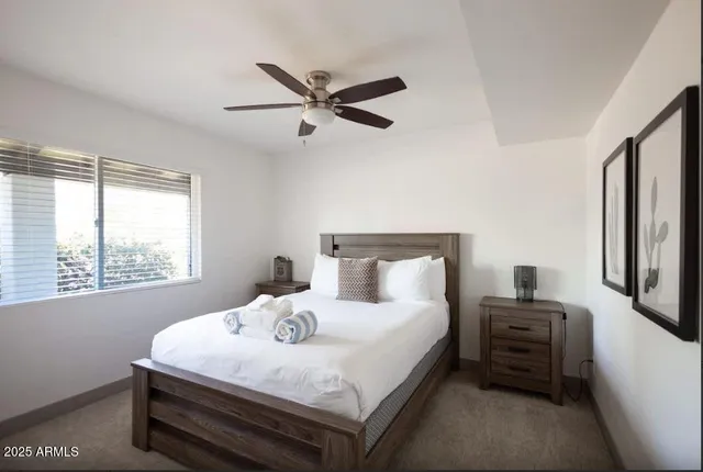 a bedroom with a bed a dresser and a window