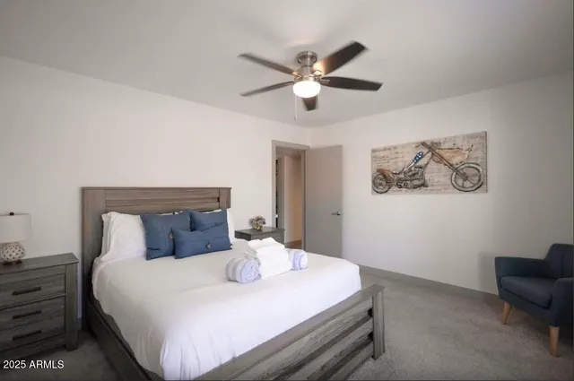 a bedroom with a bed and a chandelier