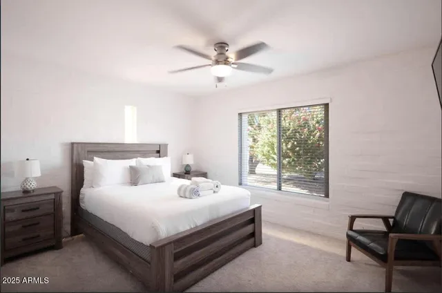 a bedroom with a bed and window