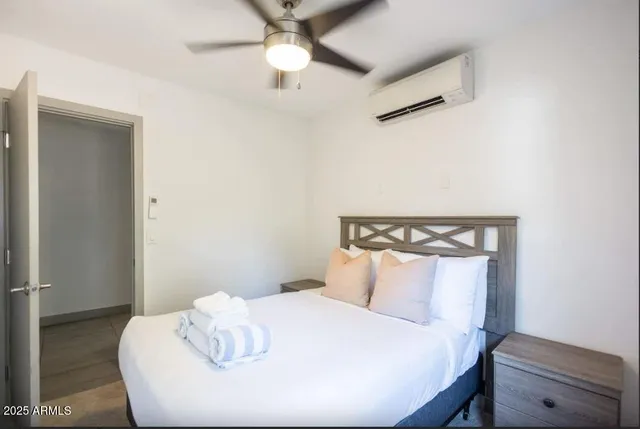 a bedroom with a bed and a dresser