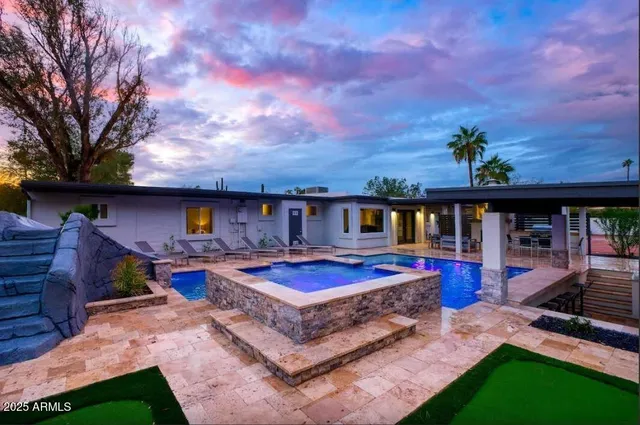 a view of a backyard with furniture and a yard