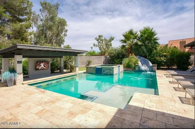 a view of a patio with a table and chairs under an umbrella