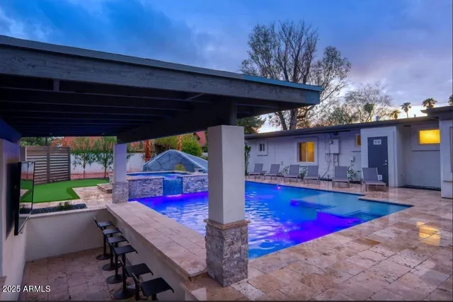 a view of swimming pool with a patio