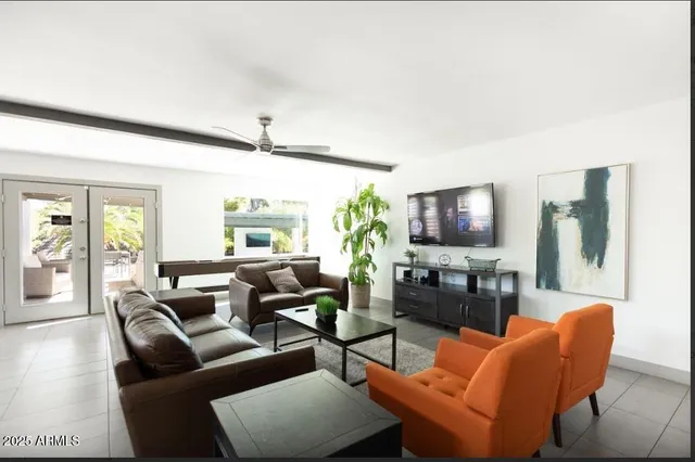 a living room with furniture a large window and a flat screen tv