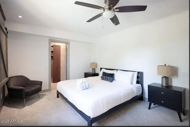 a bedroom with a bed and a chair