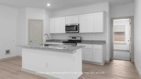 a view of kitchen with granite countertop cabinets and window