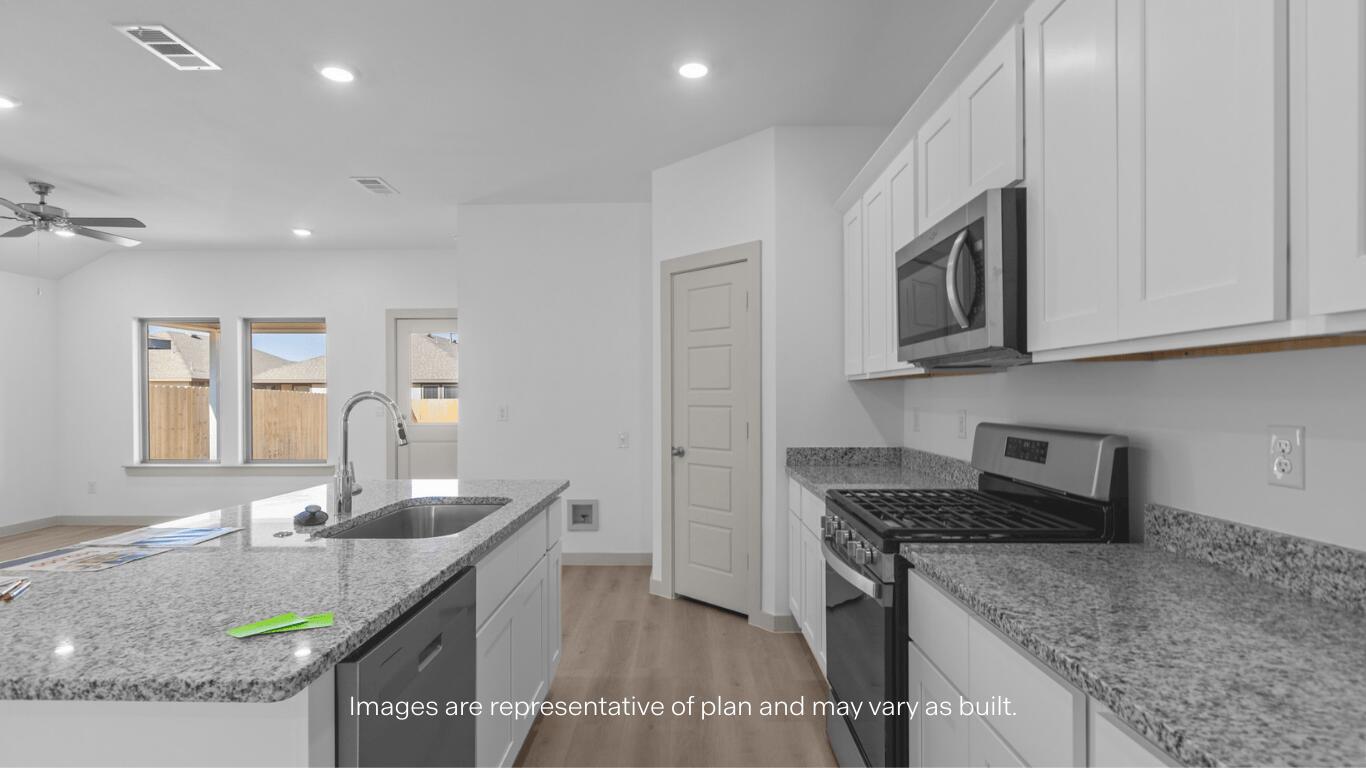 2305 150th Place Lubbock, TX 79423 - Photo 7 of 14 a kitchen with stainless steel appliances granite countertop a sink stove and cabinets