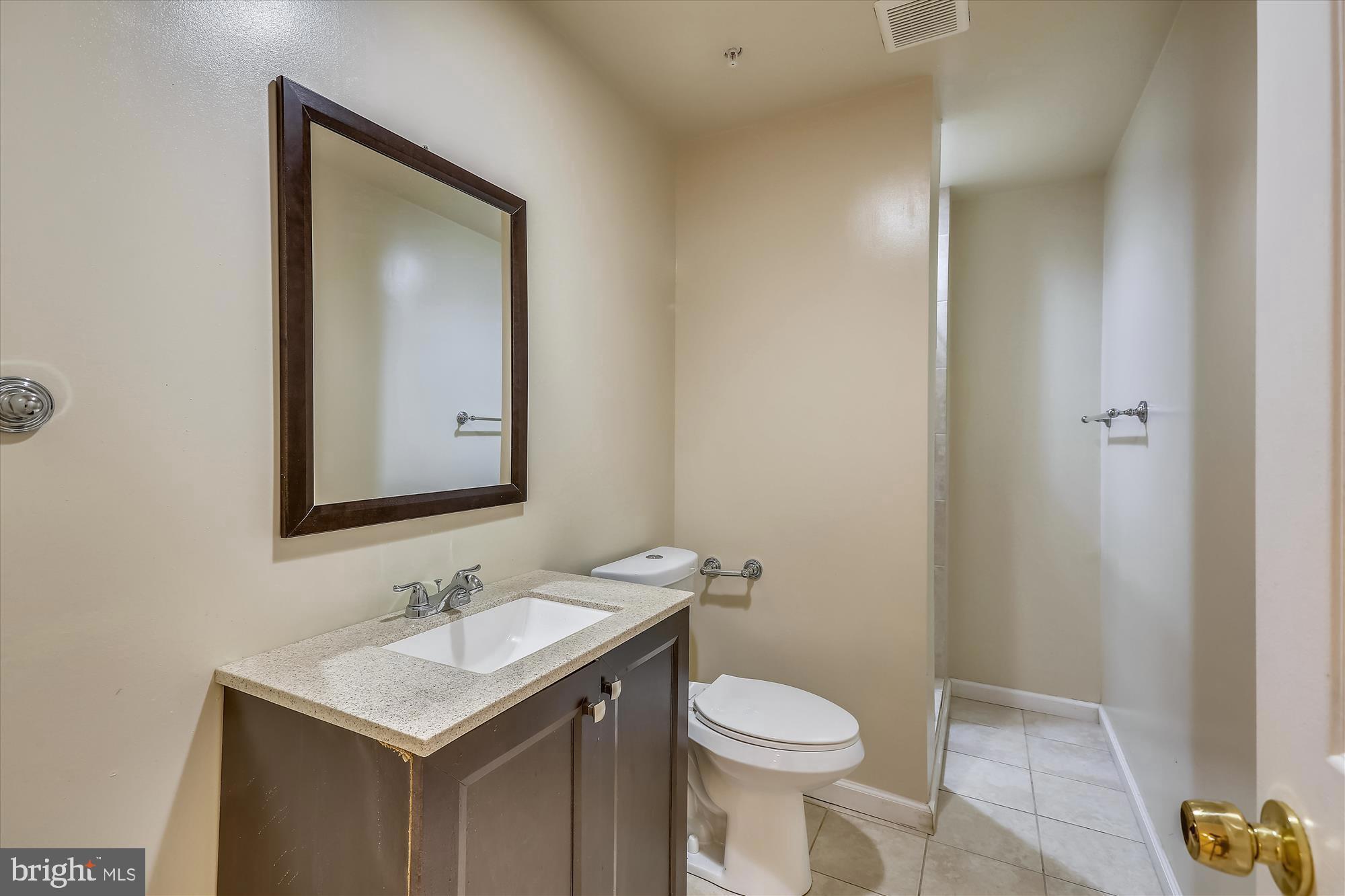 1004 Gaither Road Rockville, MD 20850 - Photo 19 of 34 a bathroom with a sink toilet and mirror