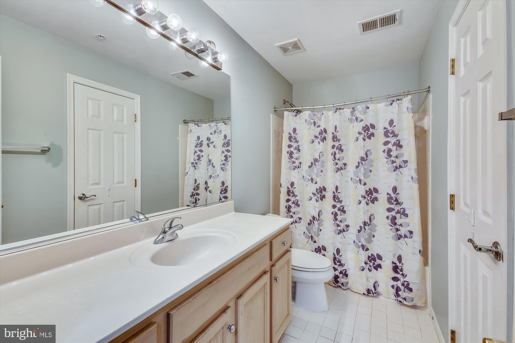 1004 Gaither Road Rockville, MD 20850 - Photo 26 of 34 a bathroom with a sink and a mirror