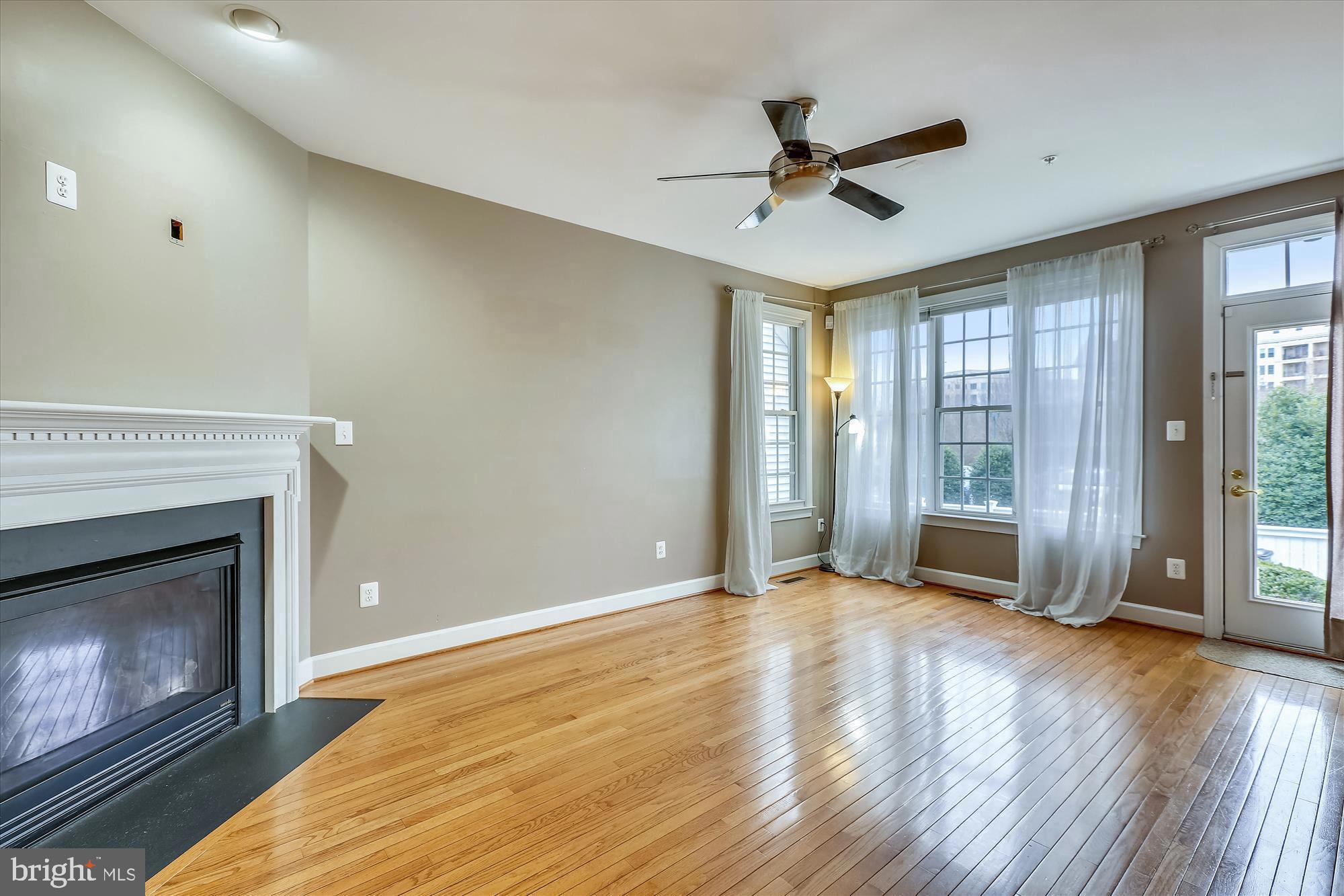 1004 Gaither Road Rockville, MD 20850 - Photo 10 of 34 a view of livingroom with hardwood floor and a ceiling fan