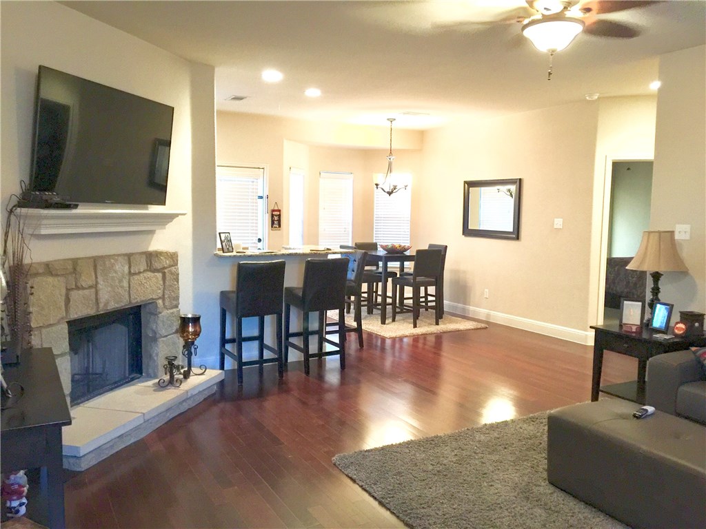 10052 Janet Loop Dripping Springs, TX 78620 - Photo 3 of 26 Woof Burning Fireplace, Engineered Hardwood Flooring and Ceiling Fan.
