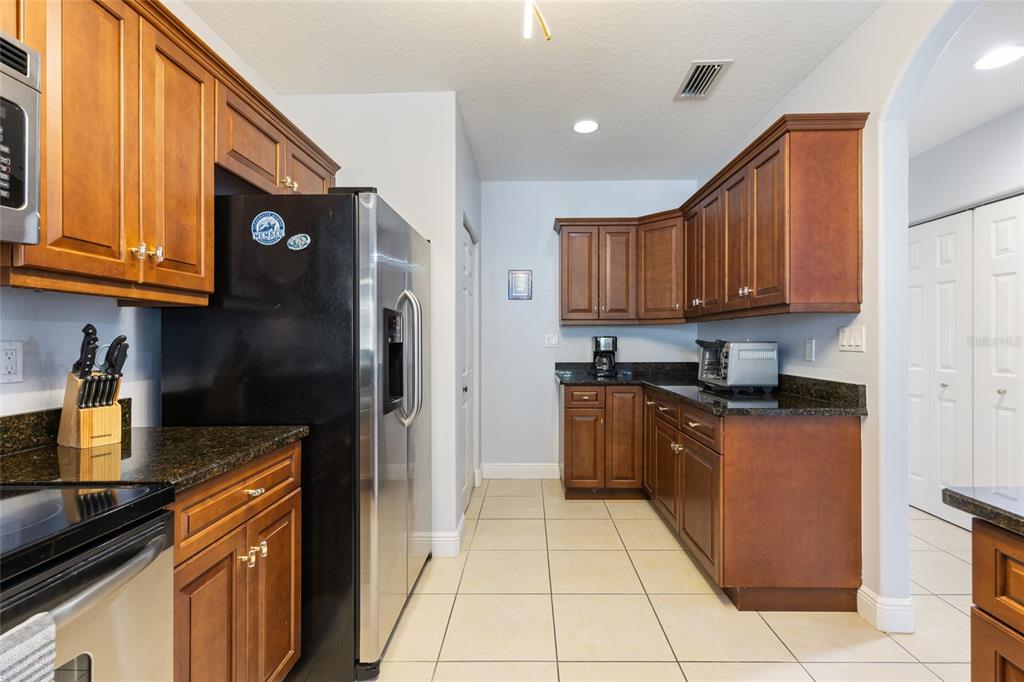141 175th Avenue East Redington Shores, FL 33708 - Photo 11 of 51 a kitchen with stainless steel appliances granite countertop a stove a refrigerator and a sink