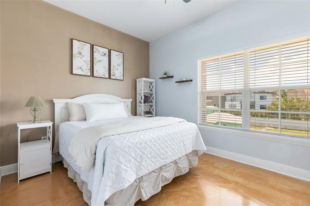 141 175th Avenue East Redington Shores, FL 33708 - Photo 15 of 51 a bedroom with a large bed and a large window